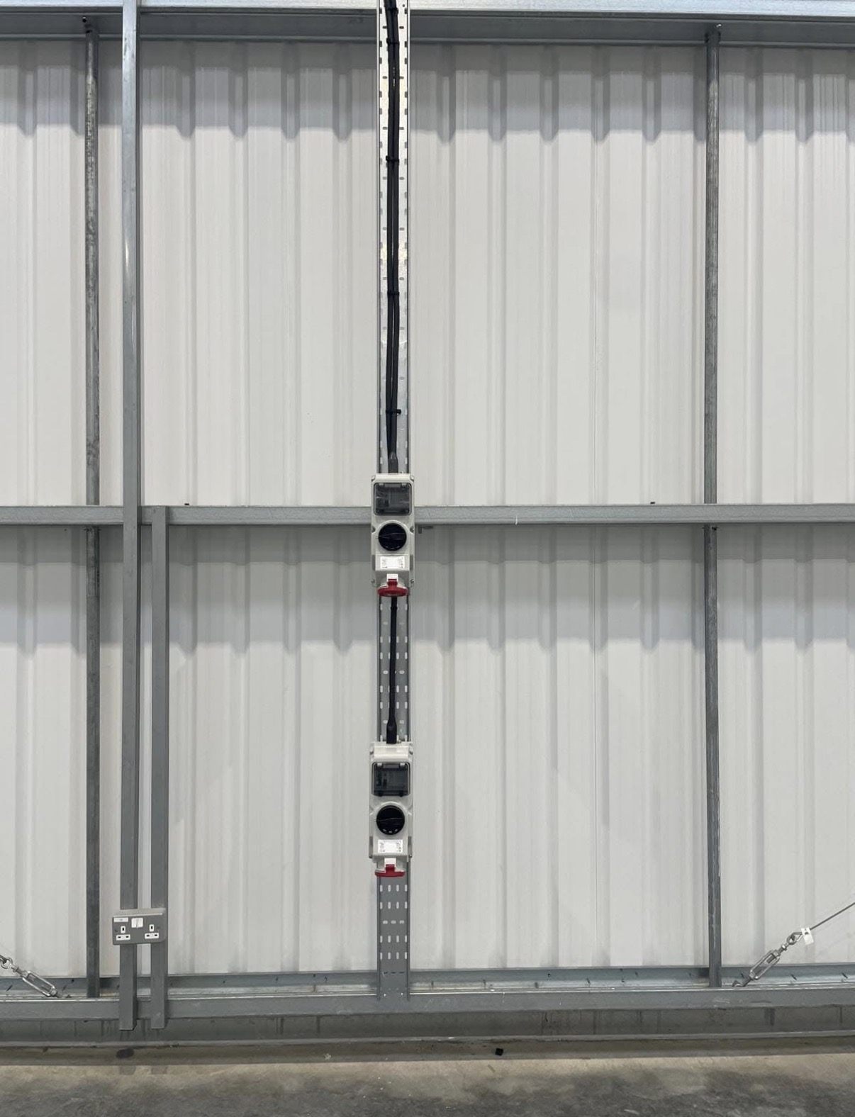 Industrial power outlets installed on vertical cable containment